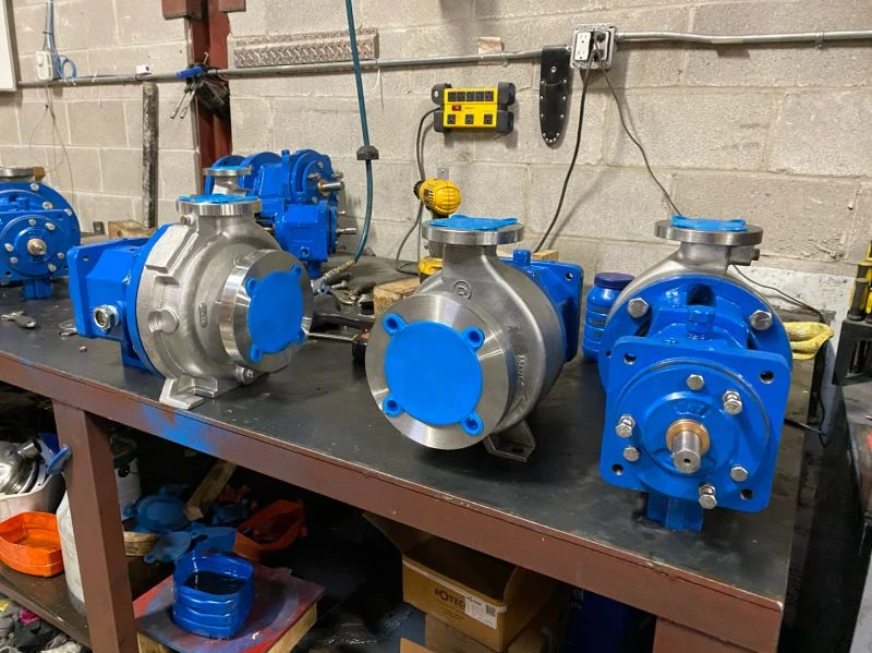 Rotech stainless process pump assemblies with blue power ends, third-party photography reference